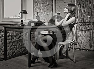 Elegant woman in black with the old typewriter