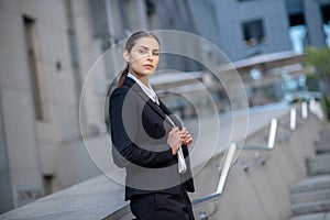 Elegant woman in a black suit looking serious