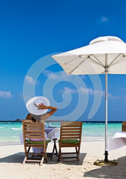 Elegant woman at breakfast on a sandbank