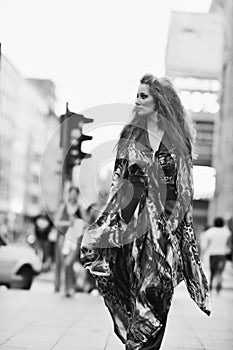 Elegant woman on city street at night