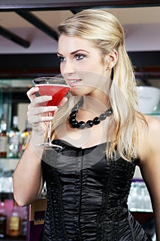 Elegant woman drinking martini cocktail