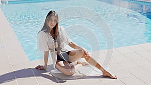 Elegant Woman Enjoying Sunny Day by the Poolside