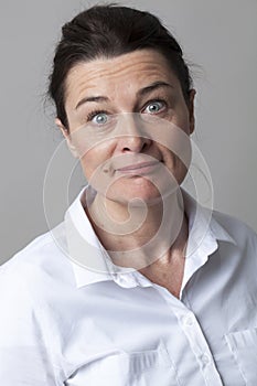 Elegant woman with eyes wide open smiling with surprise