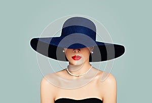 Elegant woman fashion model with red lips makeup wearing classic hat and white pearls, portrait photo