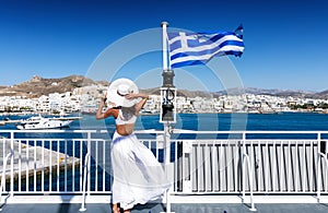 Elegant woman on a ferry boat in the Cyclades of Greece