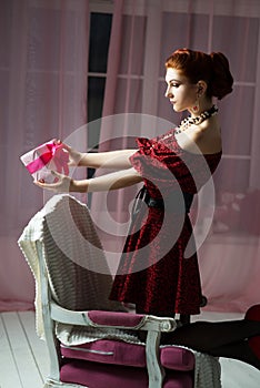 Elegant woman with gift box. Christmas tome. New Year eve