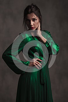 Elegant woman in green silk dress looking seductively