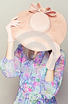Elegant woman with hats. Hides the face.
