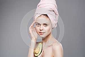Elegant woman holding a pink towel on her head in her hand Exotics fruits clean skin cosmetics