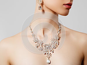 Elegant woman with jewelry. Beautiful woman with diamond necklace. Young beauty model with diamond pendant and earrings