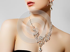 Elegant woman with jewelry. Beautiful woman with diamond necklace. Young beauty model with diamond pendant and earrings