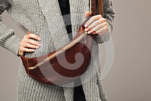 Elegant woman with a leather fanny pack