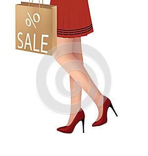 Elegant woman legs with red high heels holding a sale shopping bag