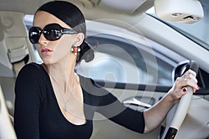 Elegant woman with long legs in car