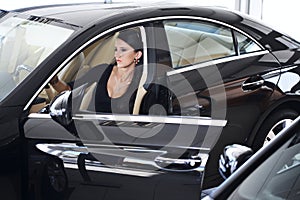 Elegant woman with long legs in car