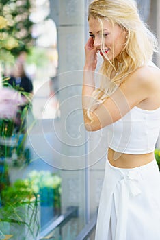 Elegant woman looking at shop window