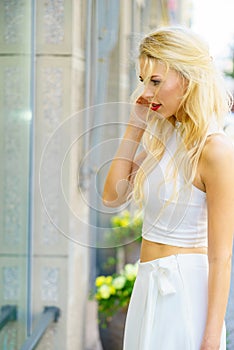 Elegant woman looking at shop window