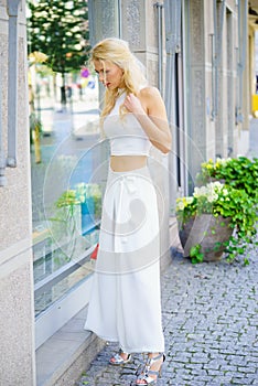 Elegant woman looking at shop window