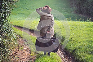 Elegant woman lost in a country road