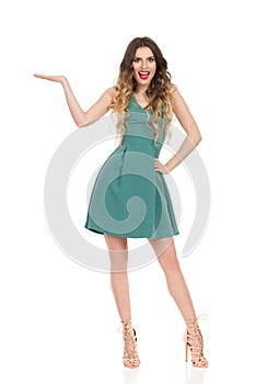 Elegant Woman In Mini Dress And High Heels Is Presenting And Talking