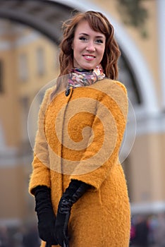 Elegant woman in the orange autumn coat