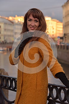 Elegant woman in the orange autumn coat