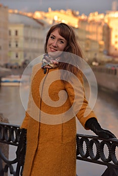 Elegant woman in the orange autumn coat