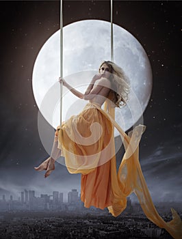 Elegant woman over big moon background