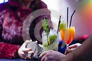 Elegant Woman Pays for Cocktails While Bartender Serving