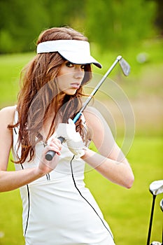 Elegant woman playing golf