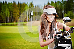 Elegant woman playing golf on a green woman