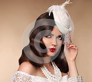 Elegant woman portrait in retro hat. Pin up girl wears in pearls