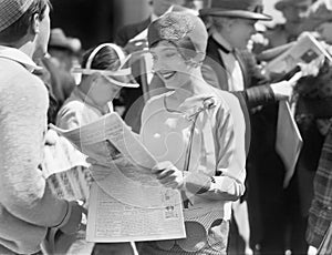 Elegant woman reading a newspaper