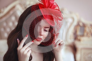 Elegant woman in retro hat with red lips and manicured nails. Br