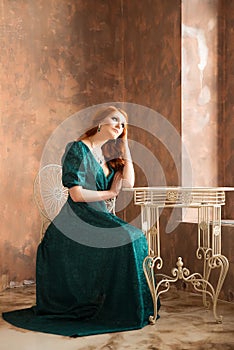 Elegant woman in retro style sitting at the table.Elegant sad woman in retro style. Depression