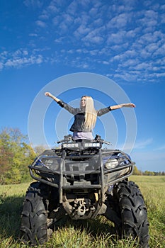 Elegant woman riding extreme quadrocycle ATV