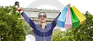 Elegant woman with shopping bags rejoicing on Champ Elysees