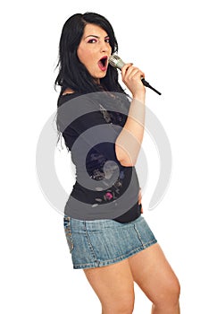 Elegant woman singing with microphone