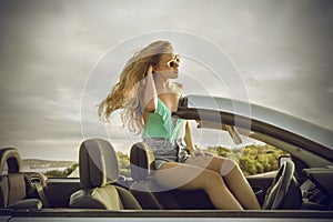 Elegant woman sitting in a classy car