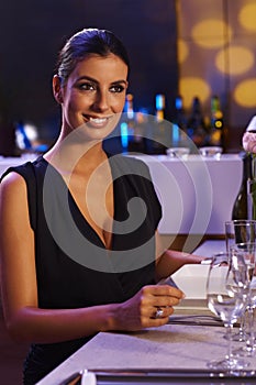 Elegant woman sitting at dinner table