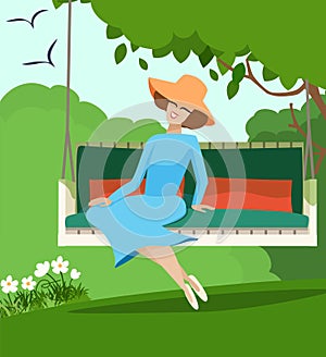 Elegant woman sitting on a garden swing