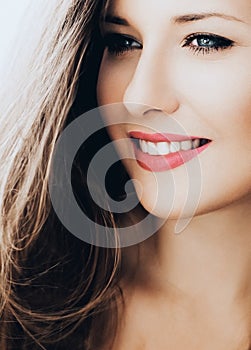 Elegant woman smiling, brunette with long light brown hair, model wearing natural makeup look, female showing healthy