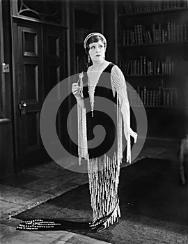 Elegant woman standing in a library