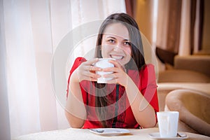 Elegant woman with a tea mug in cafe