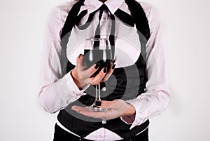 Elegant woman with tie holding wineglass with red wine isolated on white background