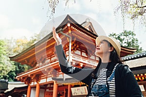 Elegant woman touching blooming flower in spring