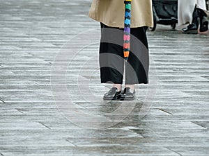 Elegant Woman in Trench Coat Holds Umbrella: Soft Bokeh View