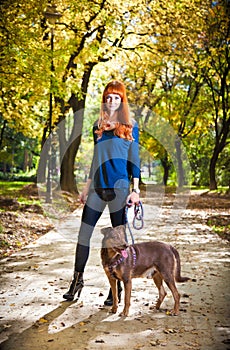 Elegant woman walking her big dog in the park, Serbia.