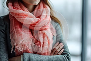 Elegant Woman Wrapped in Cozy Pink Scarf for Winter Warmth.