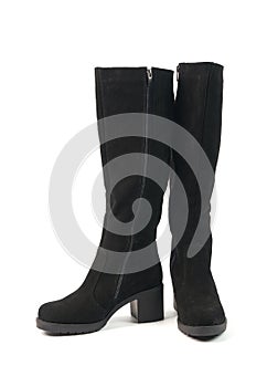 Elegant women`s tall black winter high heeled boots isolated on white background